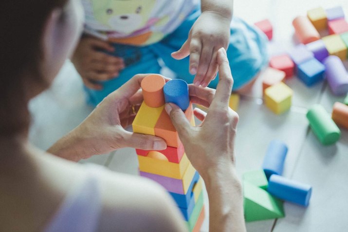 Mother And Child Playing With Blocks At Home